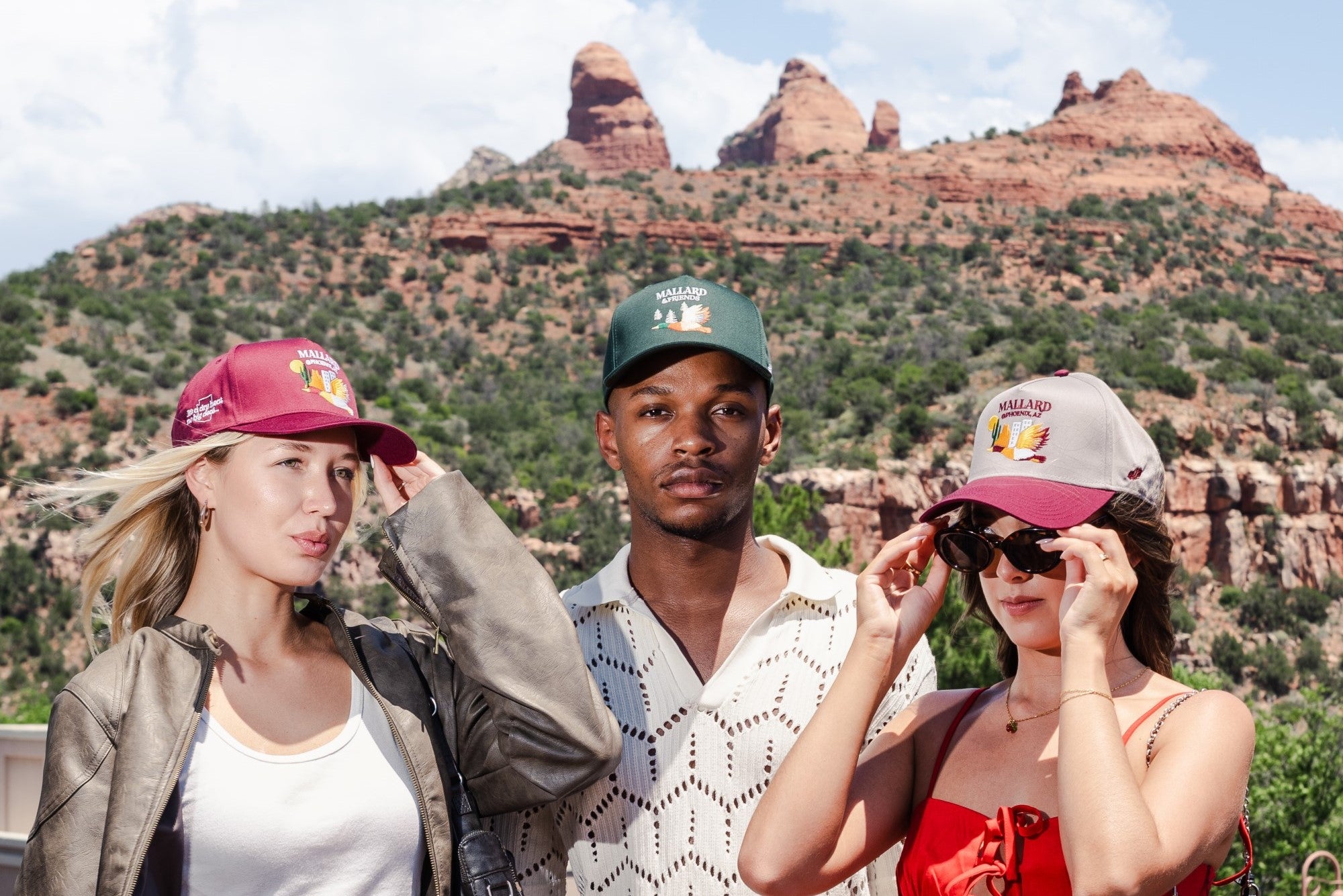 Two women and one man wearing Mallard and Friends Five Panel Hats with a canyon in the background